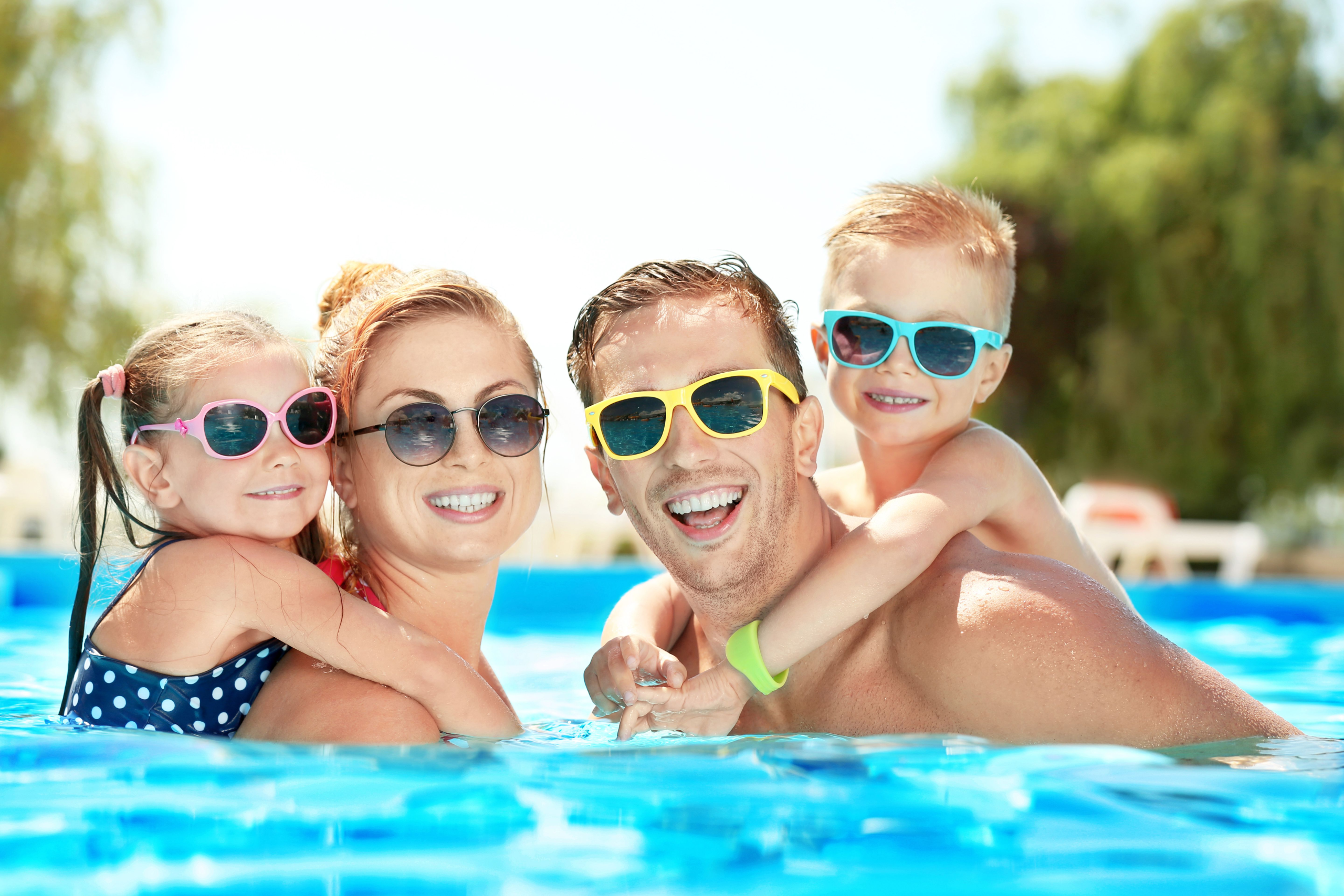 Family enjoying a swimming pool heated by SolarAttic solar pool heater